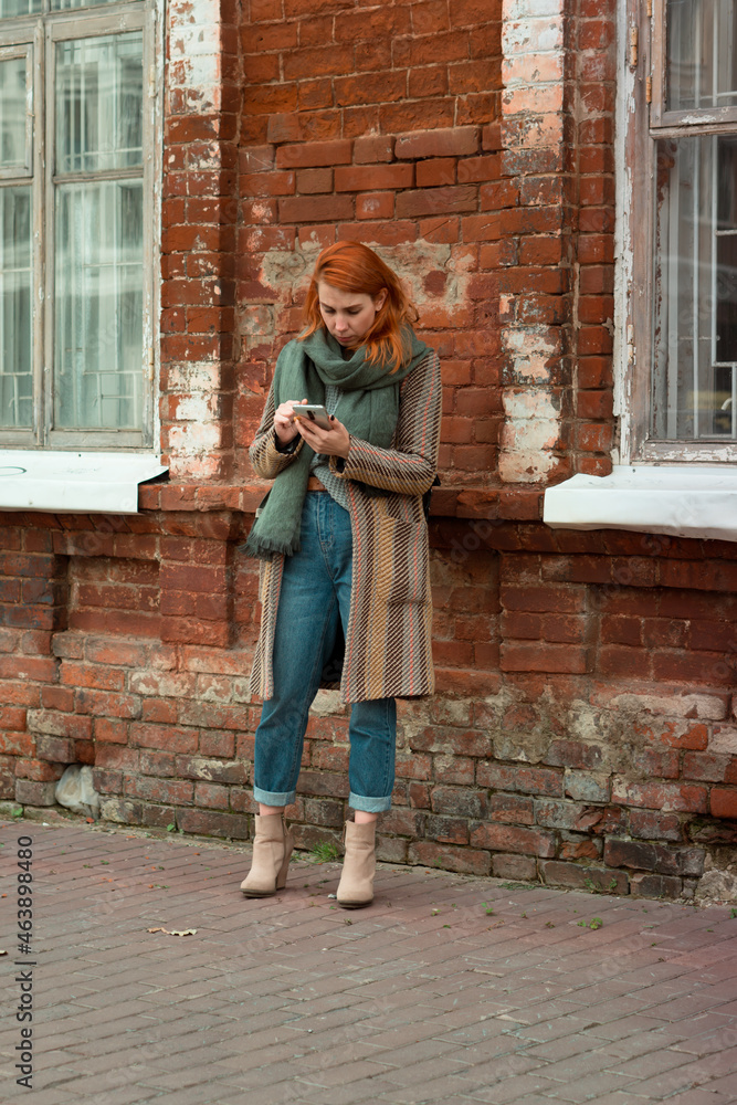 person standing on a street using phone person standing on a street using phone