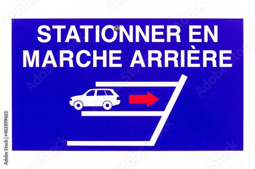 Reverse parking only sign on a wall called stationner en marche arriere in french language  photo