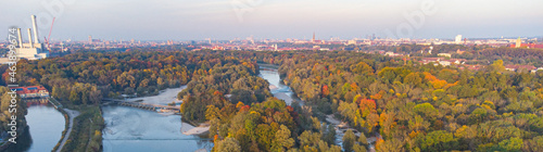 Aerial views of autumn in Munich. Isar river seen from above with colorful trees nearby
