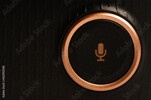Microphone icon on black button with golden ring