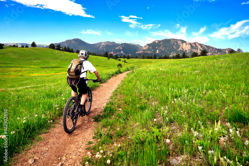 Mountain biker rides the Flatirons VIsta Trail near Boulder, Colorado