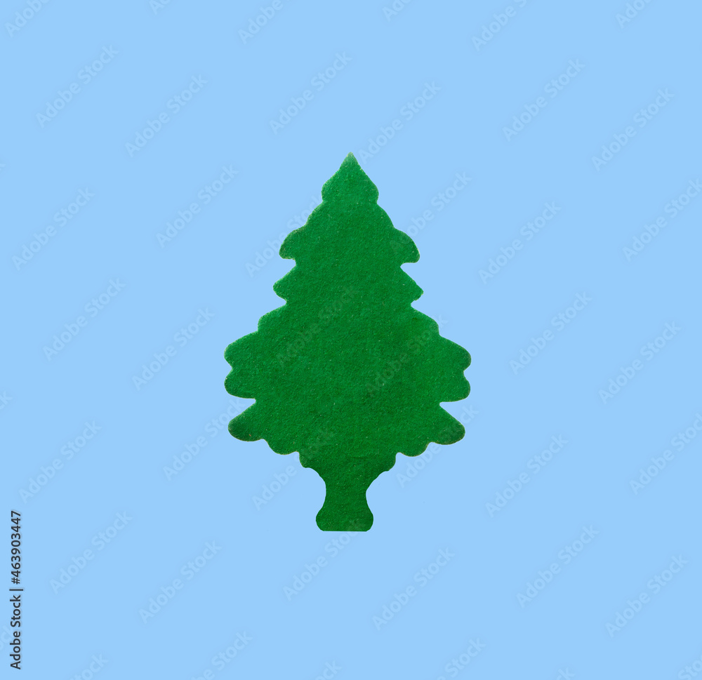 green tree made of green velvet cardboard on a blue background green tree made of green velvet cardboard on a blue background