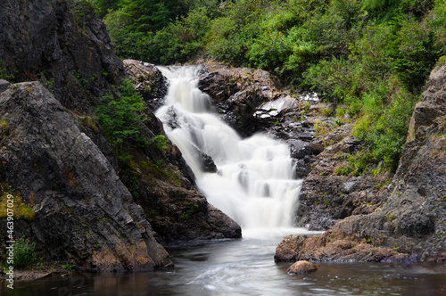 Summer swimming hole with a waterfall