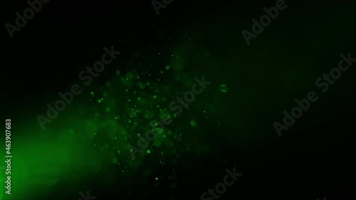 The falling particles on a green light background
