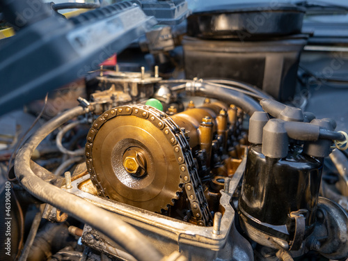 Mechanic repairing old engine with lighting