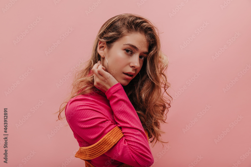 Close-up gorgeous photo of gentle ukrainian blonde enjoying herself on pink background. Soft touch to her cheek and long wavy hair in vibrant vintage outfit. Female beauty concept Close-up gorgeous photo of gentle ukrainian blonde enjoying herself on pink background. Soft touch to her cheek and long wavy hair in vibrant vintage outfit. Female beauty concept