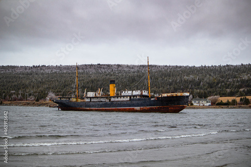 Old sunken whaling ship near shore photo