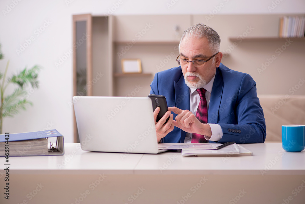 Old male employee working from home during pandemic Old male employee working from home during pandemic
