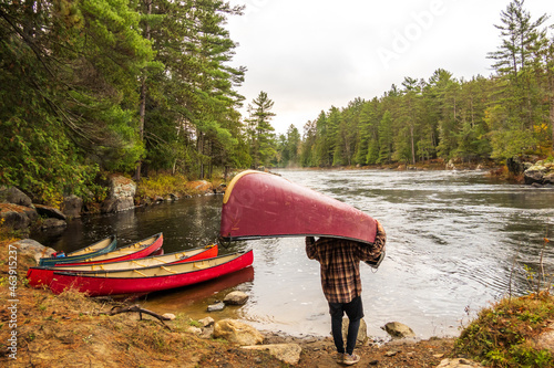 A canoe being portaged to a put in a on the Madawaska River on a fall day in Eastern Ontario, Canada. photo