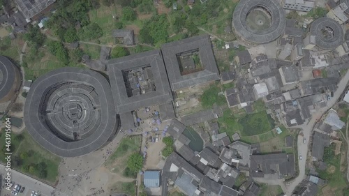 Traditional earthen Tulou Chinese huts, a landmark tourist attraction from the Fujian province of China. These large round huts are still being lived in today by the Hakka people. (aerial view) photo