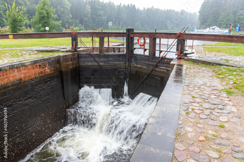 Old river lock of a shipping canal built in the 20th century with wooden mechanics. Augustow Canal, Belarus