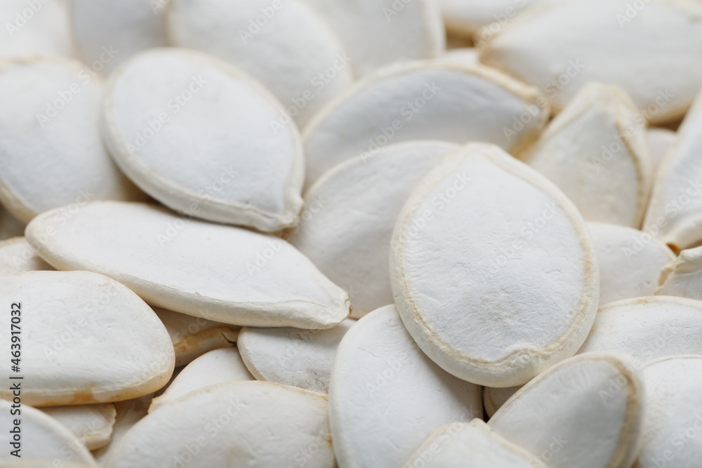 Pumpkin seeds in a shell as a textural background. Pumpkin seeds in a shell as a textural background.