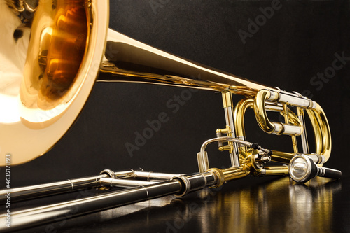 Trombone with transposer on a black table front view