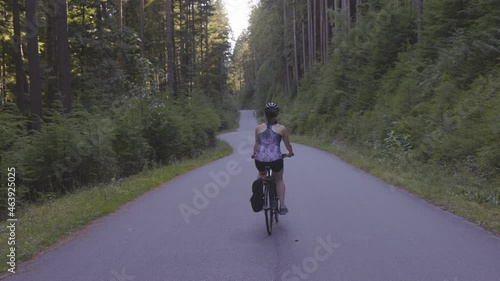 Wallpaper Mural Adventurous White Caucasian Woman on a bicycle riding on a path in Green Canadian Rain Forest. Seymour Valley Trailway in North Vancouver, British Columbia, Canada. Slow Motion Torontodigital.ca