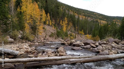 Flying low over the Provo River cascading down canyon in the Uinta Mountains viewing colorful trees during the Fall. photo