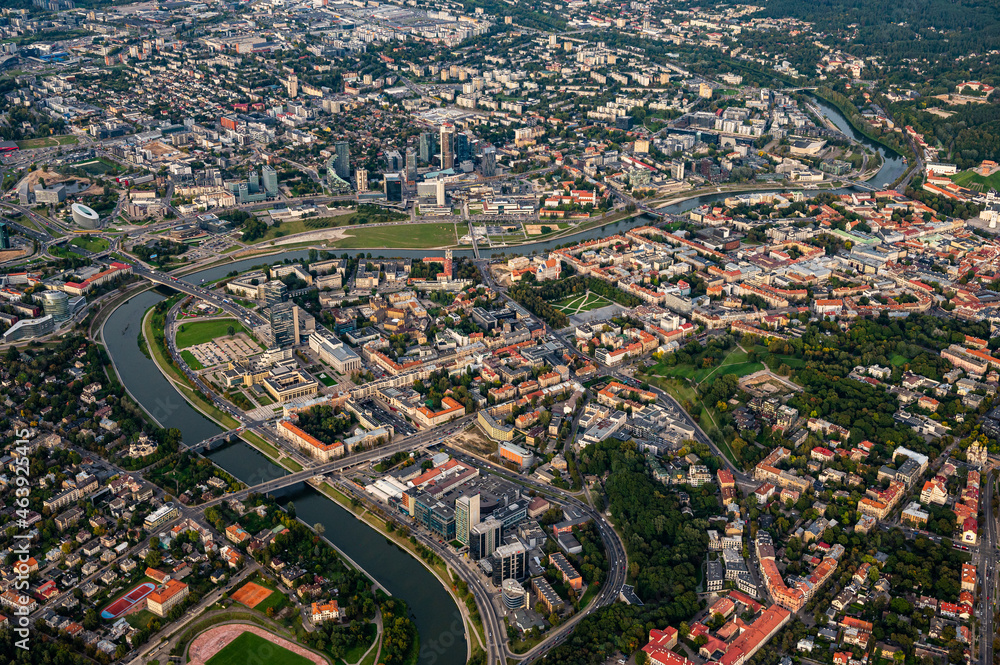 Scenic view on central part of Vilnius capital of Lithuania from hot air balloon. Neris river flowing curve through the city. Downtown district view from the sky