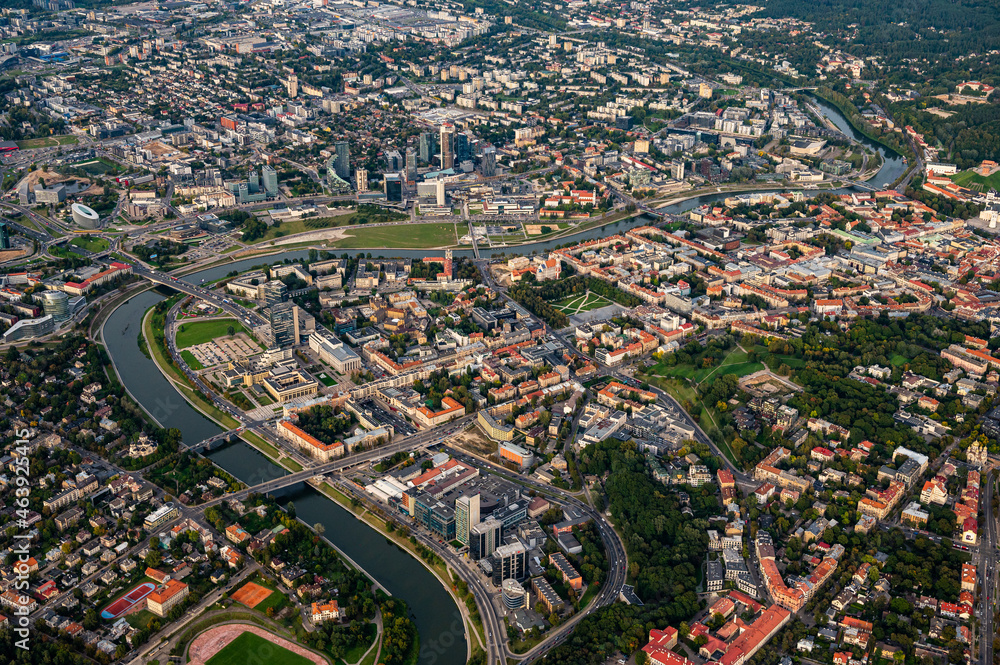Obraz premium Scenic view on central part of Vilnius capital of Lithuania from hot air balloon. Neris river flowing curve through the city. Downtown district view from the sky