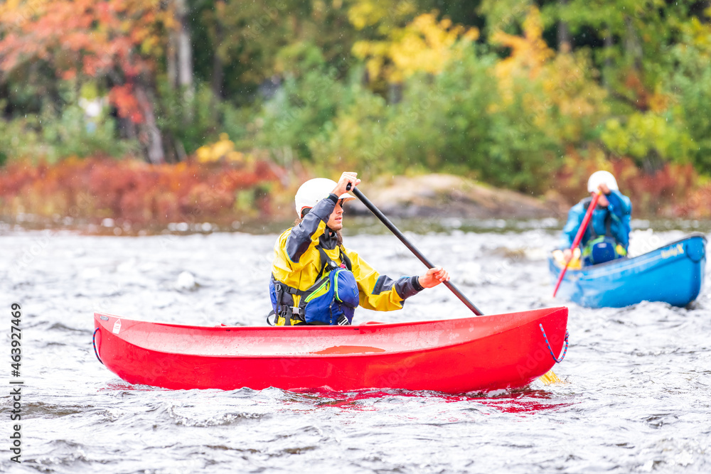 A solo canoeist practices strokes on a rainy fall day during a “moving water” paddling course. Shot at Palmer Rapids on the Madawaska River an iconic paddling destination in Eastern Ontario, Canada A solo canoeist practices strokes on a rainy fall day during a “moving water” paddling course. Shot at Palmer Rapids on the Madawaska River an iconic paddling destination in Eastern Ontario, Canada
