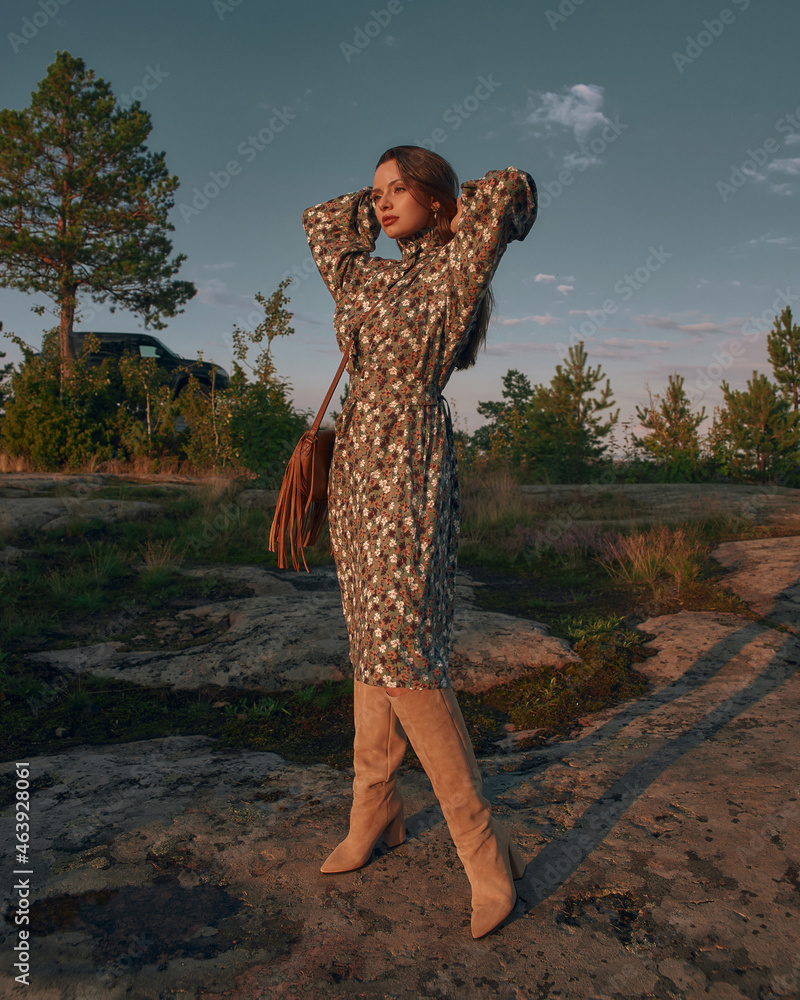 Elegant woman in green dress and high boots wearing green dress and ...