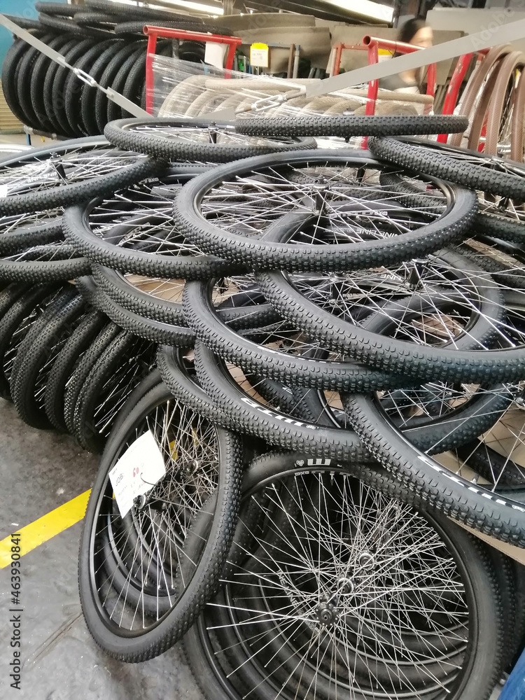 bicycle wheels piled on the floor 
