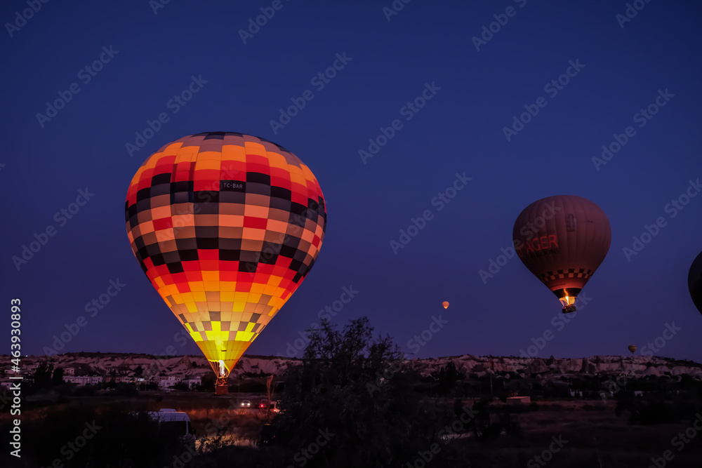 Naklejka premium Hot air balloon flying over spectacular Cappadocia. Hot air balloon flying over spectacular Cappadocia
