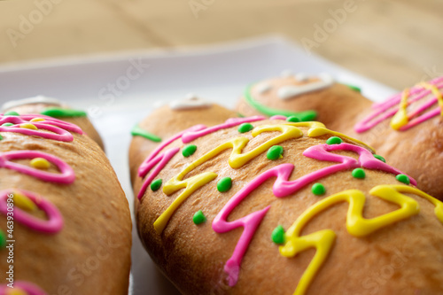 Close up of the decoration of a Guagua de pan, a traditional ecuadorian doll shaped bread garnished with colorful sugar. Ecuador's day of the dead concept. Gastronomic culture. 