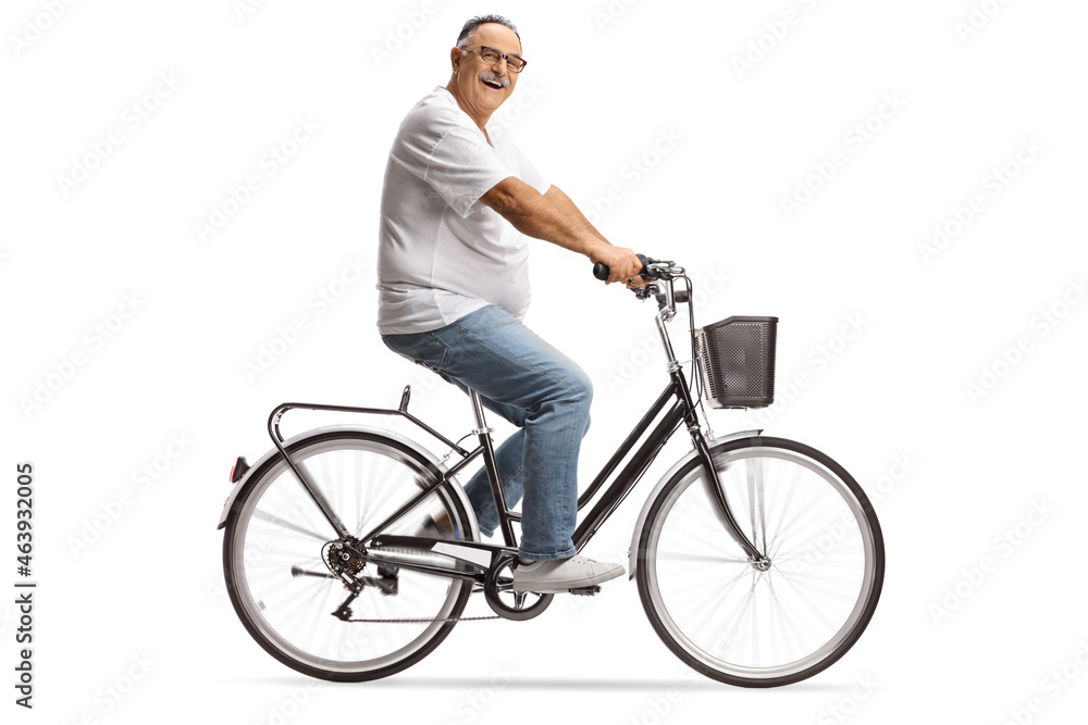 Smiling mature man in jeans and white t-shirt riding a bicycle Smiling mature man in jeans and white t-shirt riding a bicycle
