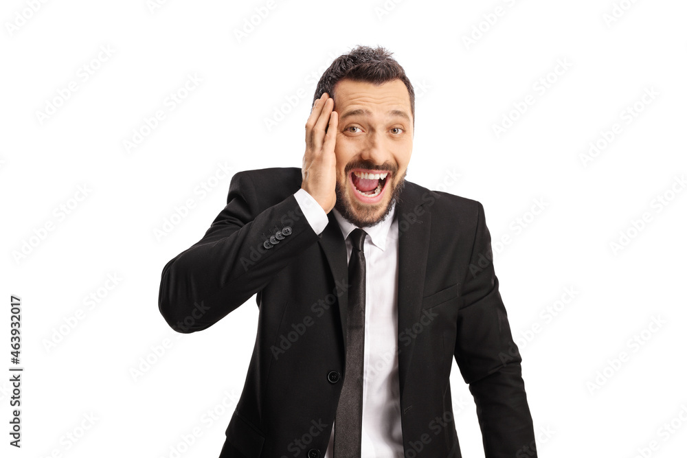 Young businessman laughing and holding his head Young businessman laughing and holding his head