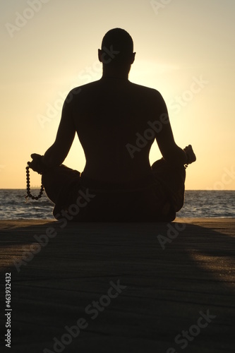 a man meditates at dawn