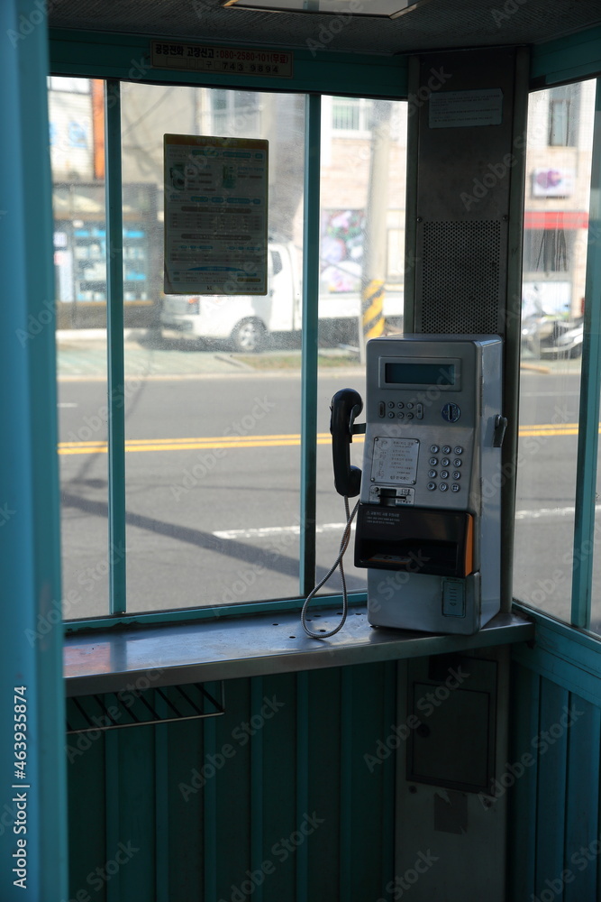 empty phone booth on the corner of the street in jeju island empty phone booth on the corner of the street in jeju island