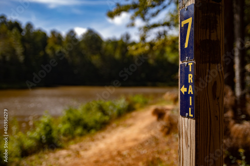 trail head Hiking trail marker near lake hiker's background