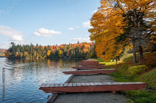 Docks on a lake highlighted by fall foliage.