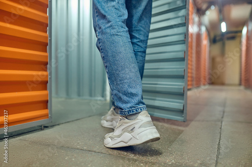 Legs of man entering open container door