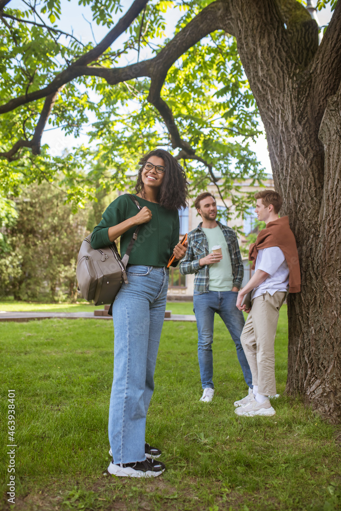 A group of young people spending time together in the park A group of young people spending time together in the park