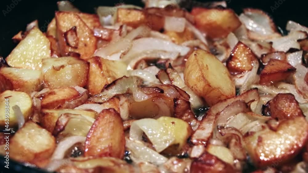 Potatoes with onion are frying in oil.Closeup view.Roasted baby potatoes in iron skillet.Fried crispy potatoes in a pan.Cooking delicious potatoes fries in hot oil.Unhealthy and oily food. Fast food. Potatoes with onion are frying in oil.Closeup view.Roasted baby potatoes in iron skillet.Fried crispy potatoes in a pan.Cooking delicious potatoes fries in hot oil.Unhealthy and oily food. Fast food.