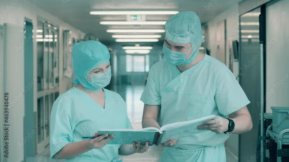 Surgeons are browsing the documents in the corridor Surgeons are browsing the documents in the corridor