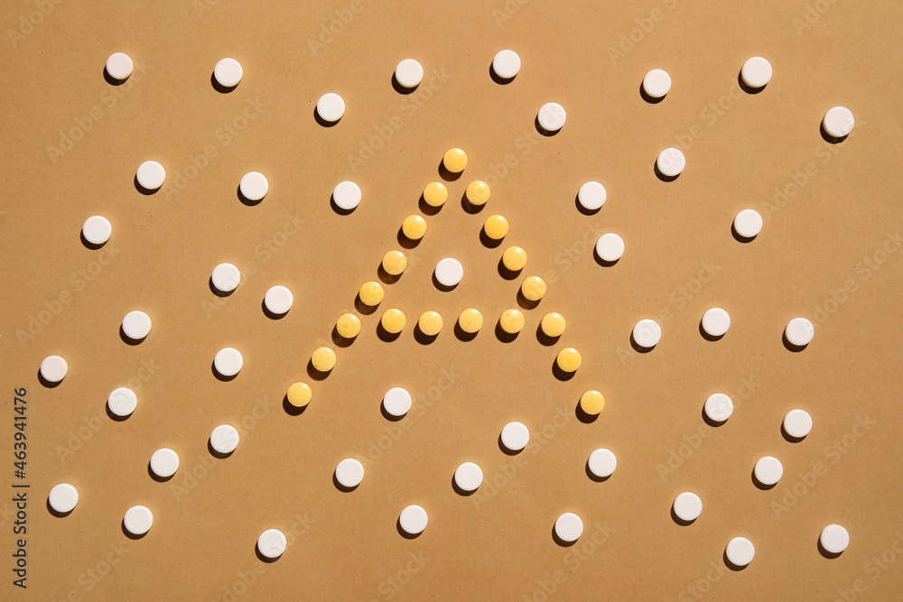 Fototapeta premium Letter A made of pills on color background