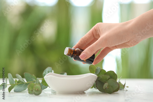 Woman adding essential oil ...