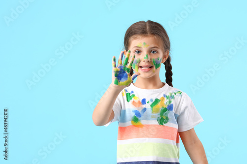 Little girl in paint on blu...
