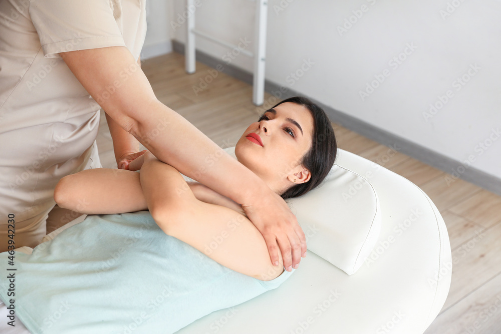 Fototapeta premium Young woman lying on couch in rehabilitation center