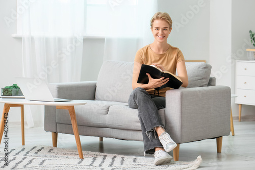Young woman reading Holy Bi...