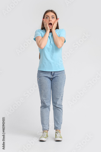 Shocked young woman in blue...