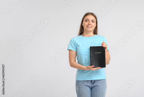 Young woman with Holy Bible...