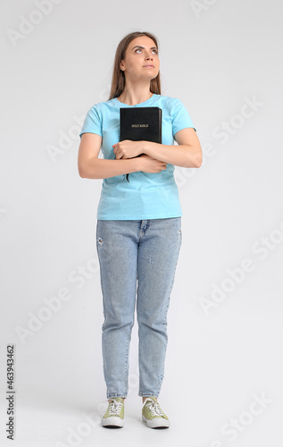 Young woman with Holy Bible...
