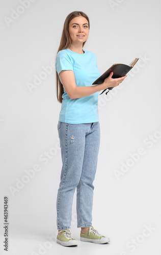 Young woman reading Holy Bi...
