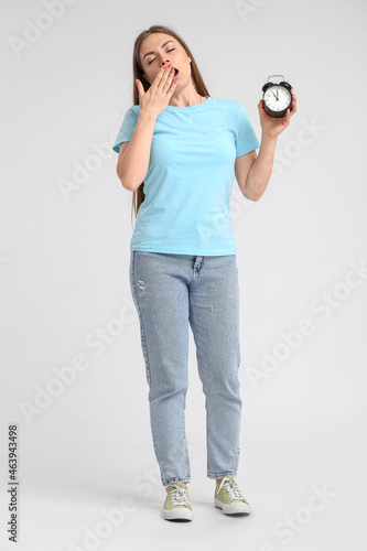 Young woman with alarm cloc...