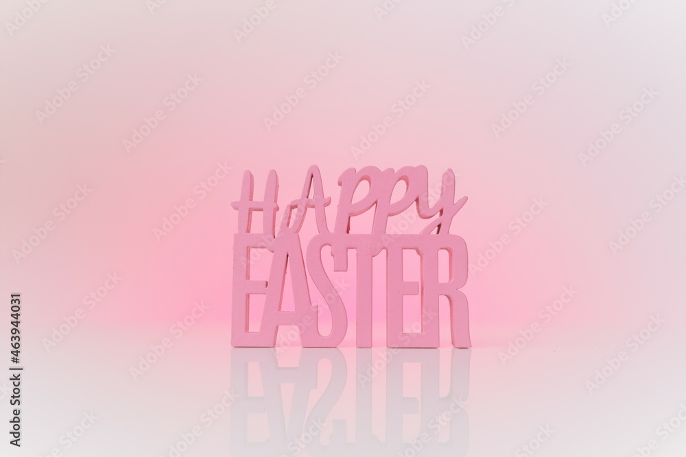 Easter holiday.Happy easter inscription on a light pink background.Religious holiday background. 