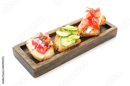 Board with tasty vegetarian bruschettas on white background