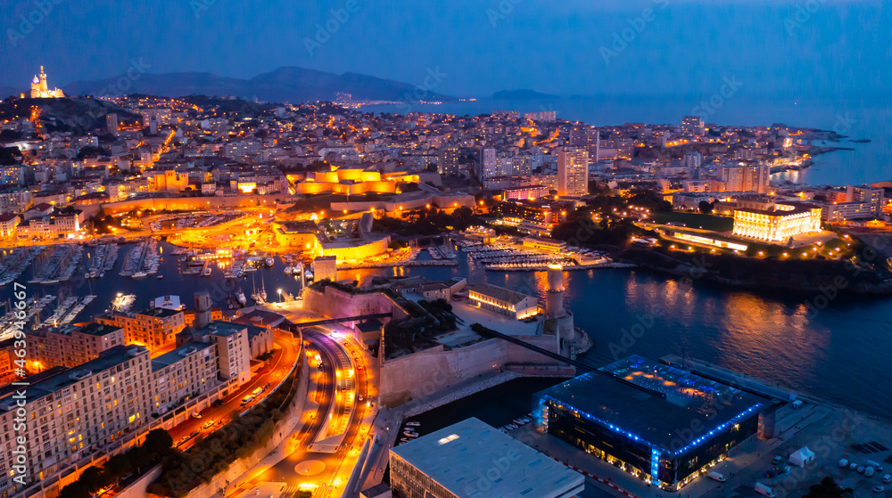 Panoramic night view of the old port and Notre Dame de la Garde Cathedral, city of Marseille in South France