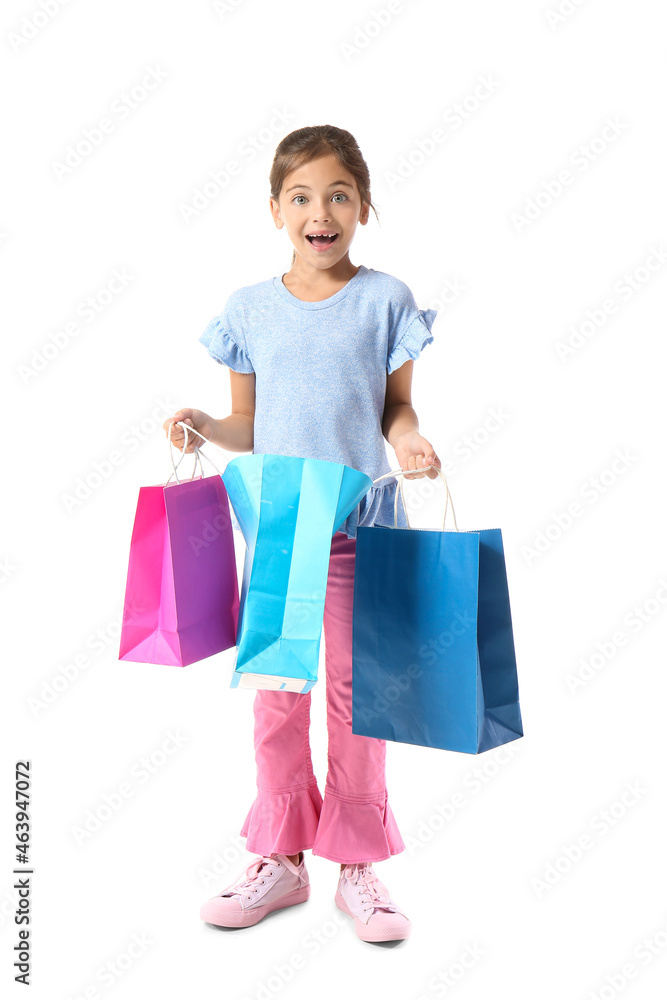 Surprised little girl with Black Friday shopping bags on white background
